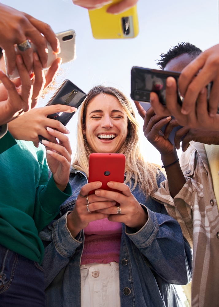 Low,Angle,View,Of,A,Group,Of,Young,Teenagers,Friends youth with mobile phones